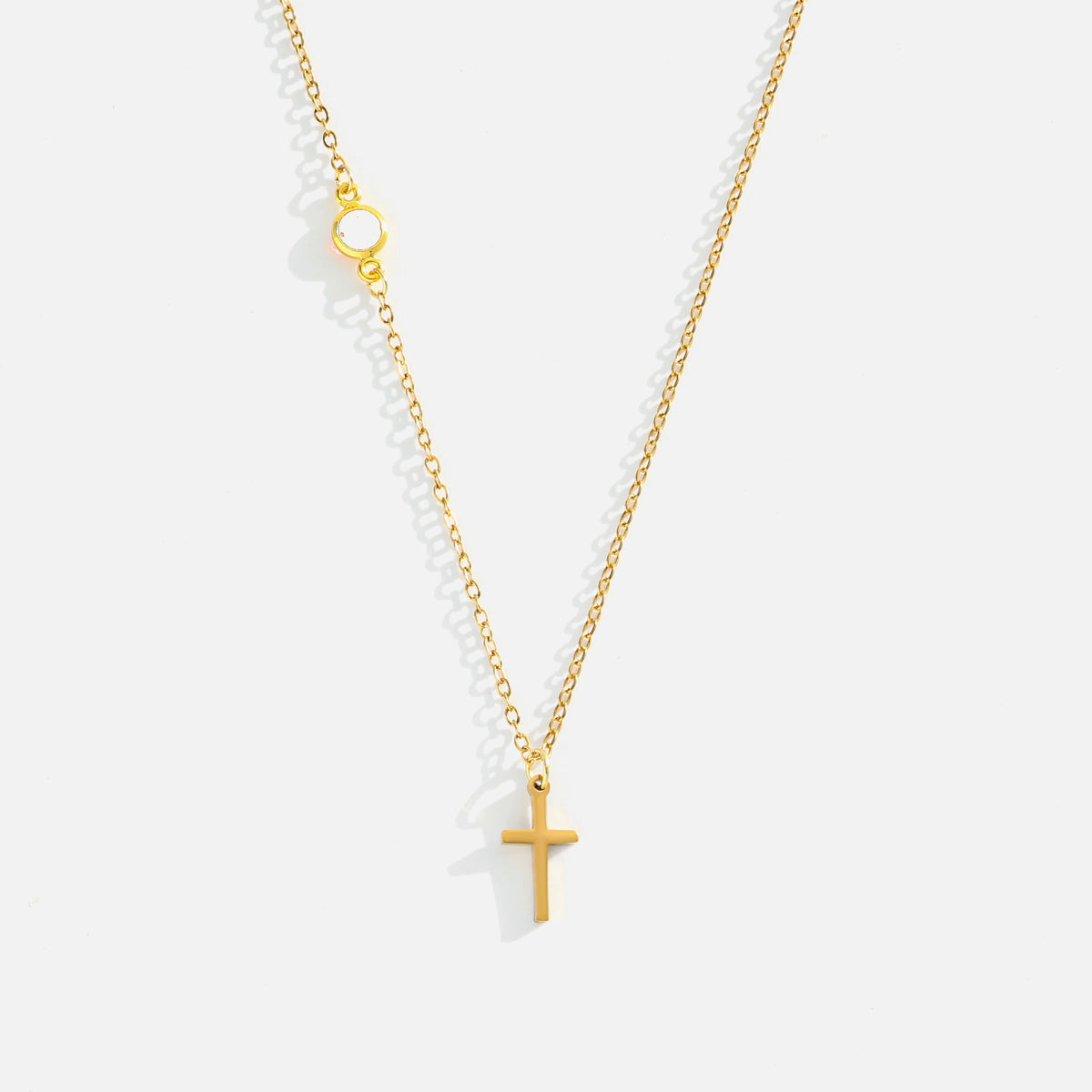 Dainty Birthstone Cross Necklace — studio shot