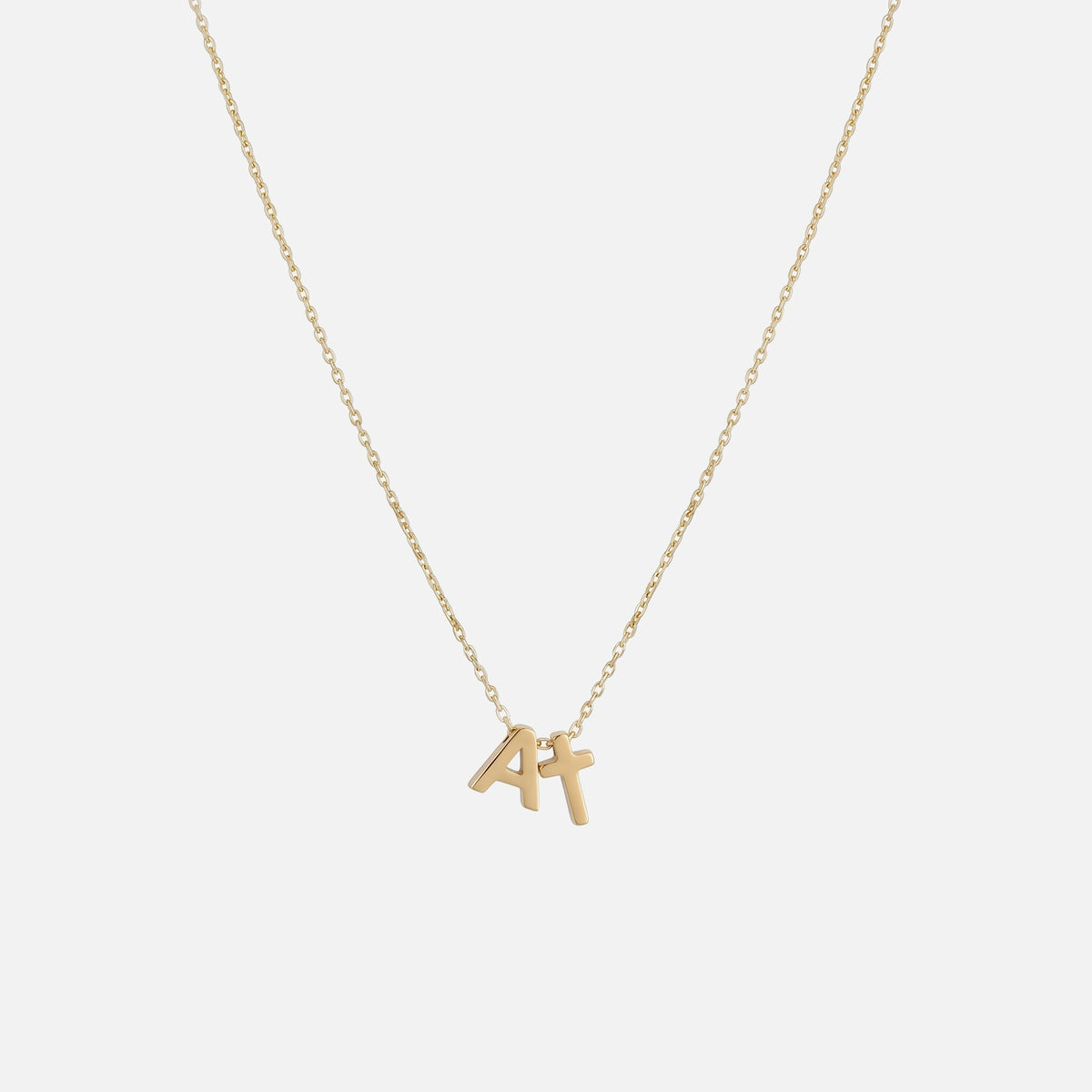 Initial Cross Necklace — studio shot
