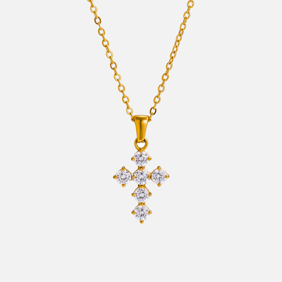 Petite Cross Necklace — studio shot on light grey