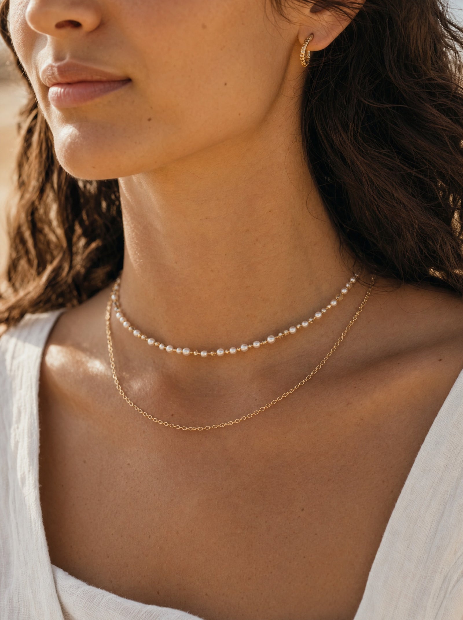 Layered pearl and gold necklaces close-up